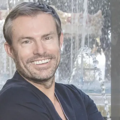 Dr. Kai O. Kaye in medical scrubs with a friendly expression