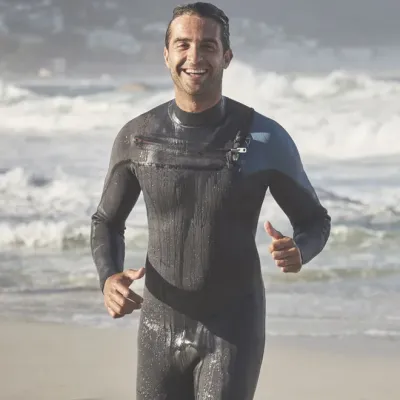 Middle-aged man in wetsuit showing a fit and active body