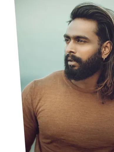 Man with a strong build and natural appearance wearing a casual shirt