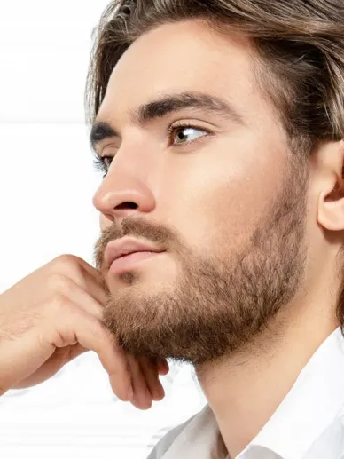 Young man with a beard in side profile and clear skin